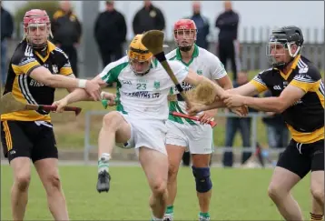  ??  ?? Seamus Carroll boots the sliothar away from Askamore’s Gavin Sunderland and Frank Boggan.