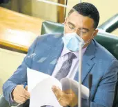  ?? KENYON HEMANS/PHOTOGRAPH­ER ?? Prime Minister Andrew Holness pores over a document during Tuesday’s sitting of the House.