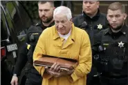  ?? GENE J. PUSKAR, FILE - THE ASSOCIATED PRESS ?? In this Nov. 22 photo, former Penn State University assistant football coach Jerry Sandusky, center, arrives at the Centre County Courthouse to be resentence­d in Bellefonte, Pa. Sandusky‚Äôs bid for a reduced prison term was thwarted after a judge gave him the same sentence, 30 to 60 years, that was imposed in the wake of his 2012 conviction for sexually abusing children.