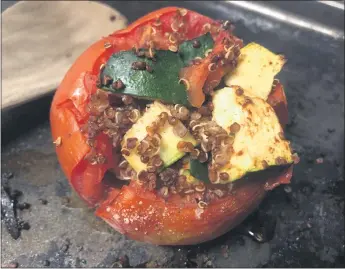  ?? PHOTOS BY NATALIE HANSON — ENTERPRISE-RECORD ?? Stuffing and baking a tomato uses up the ripest of large tomatoes alongwith fresh zucchini.