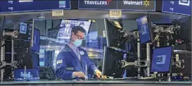  ?? Courtney Crow / Associated Press ?? Specialist John Mcnierney works at his post on the floor of the New York Stock Exchange on Thursday.