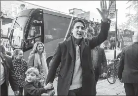  ?? AP/The Canadian Press/PAUL CHIASSON ?? Justin Trudeau, Canadian prime minister and Liberal leader, arrives at the polling station Monday with his son, Hadrian, his wife, Sophie and his daughter, Ella-Grace, in Montreal.