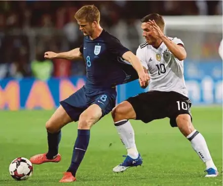  ??  ?? England’s Eric Dier (left) is challenged by Germany’s Lukas Podolski in their internatio­nal friendly in Dortmund on Wednesday.