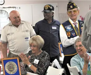  ??  ?? ABOVE: Clyde Berry, left, has just brought the house down with his joke that a few days after he was inducted into the military, the other side heard about it and quickly ended the war. Laughing and applauding are Fran Whatley, Joe Pruitt, John Fox and...