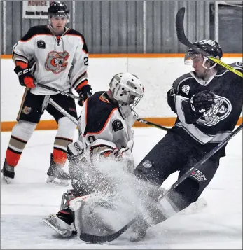  ??  ?? Coaldale’s Nolan Berner narrowly avoids a snow job by Cubs’ Noah Irvine during game 3 action in Medicine Hat Feb. 25.