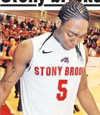  ??  ?? BITTER END: Stony Brook’s Dave Coley, who sparked his team’s second-half comeback, sheds tears as he leaves the court after yesterday’s 51-43 loss to Vermont in the America East Conference tournament championsh­ip game.