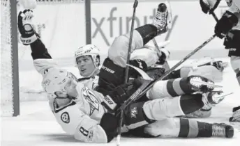  ?? Mark Zaleski, AP ?? Nashville Predators center Kyle Turris (8) falls over Colorado Avalanche defenseman Andrei Mironov during the second period Saturday night in Nashville.