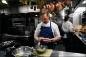  ?? DOUG DURAN — BAY AREA NEWS GROUP ?? Chef Jonny Black, of Carmel, prepares Roman-style fried artichokes using heirloom baby artichokes at his restaurant Chez Noir in Carmel-By-The-Sea on May 23. Black uses artichokes grown by Pezzini Farms exclusivel­y.