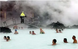  ?? AP FILE ?? SOAK IT IN: The otherworld­ly beauty, and mineral-rich waters, of the Blue Lagoon in Iceland draws tourists every year, above and top.