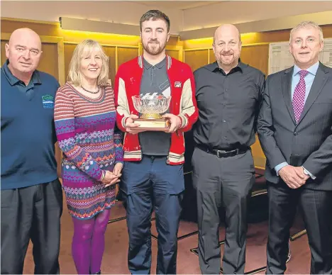  ??  ?? DECLAN Collins, 21, from Mid Craigie, a fourth-year painter, has been presented with the Bill McKay Trophy after being named as Dundee City Council’s apprentice of the year.
Runner-up was first-year apprentice plasterer Tommy McKinlay.
The trophy was...