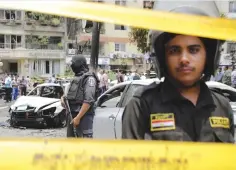  ??  ?? CAIRO: In this June 29, 2015 photo, Egyptian policemen stand guard after a bomb attack that targeted Egypt’s prosecutor general in the Heliopolis district. —AP