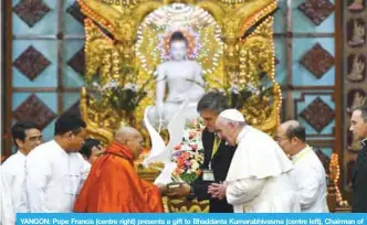  ??  ?? YANGON: Pope Francis (centre right) presents a gift to Bhaddanta Kumarabhiv­asma (centre left), Chairman of state Sanga Maha Nayaka Committee, during their meeting in Yangon yesterday. —AFP