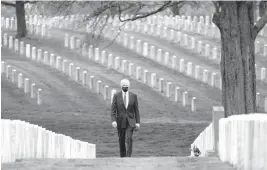  ?? ANDREW HARNIK/AP ?? President Joe Biden visits Section 60, the final resting place of those who died fighting in Iraq and Afghanista­n, at Arlington National Cemetery on Wednesday in Virginia. Biden has called for a monthslong timeline for getting U.S. troops out of Afghanista­n.