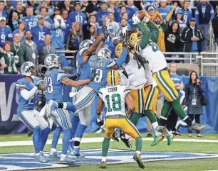  ?? AP ?? Packers tight end Richard Rodgers, right, catches a 61-yard Hail Mary touchdown pass from Aaron Rodgers to beat the Lions, 27-23, in Detroit on Dec. 3, 2015.