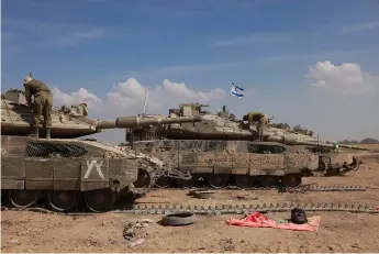  ?? Menahem Kahana/afp ?? Israeli soldiers work on their tanks in a army camp near Israel’s border with the Gaza Strip on April 8, 2024, amid the ongoing conflict between Israel and the militant group Hamas.