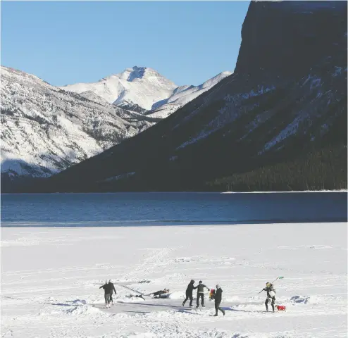  ?? Marie Conboy/postmedia; azin Ghaffari/postmedia ?? ice skaters on lake minnewanka in banff national Park on Jan. 13. four people fell through the ice last weekend and
one required a thin ice rescue response from banff visitor safety. below, a cross-country skier in Calgary.