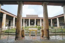  ?? ANDREW MEDICHINI AP ?? Columns frame the courtyard at the House of Vettii, a restored home in the Pompeii Archaeolog­ical Park near Naples in southern Italy.