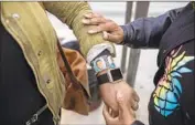  ??  ?? JACKIE JACKSON shows off her bracelet honoring her son, Bronze, who was killed at the age of 14.