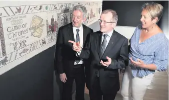  ??  ?? John McGrillen of Tourism NI, Niall Gibbons of Tourism Ireland and Kathryn Thomson of the Ulster Museum, with the tapestry. Right: Ed Sheeran in the new series