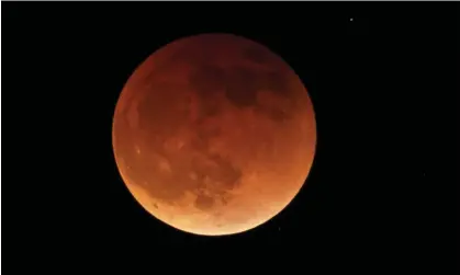  ?? ?? The blood moon during a total lunar eclipse. Here’s how, where and when to watch the November 2022 full moon. Photograph: Ted S Warren/AP