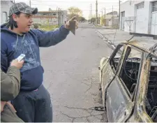  ?? FACUNDO MORALES-LA NUEVA. ?? Emiliano Bonventre observa los daños que el fuego provocó en su vehículo, estacionad­o en Paraná al 1500.