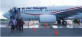  ??  ?? Micronesia … passengers disembark an Air Niugini Boeing 737 at Chuuk.