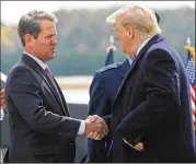  ??  ?? Gov. Brian Kemp, greeting President Trump at Dobbins AFB last month, faced intense pressure to name Doug Collins to the Senate.
