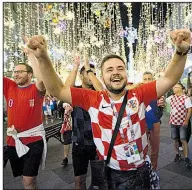  ?? AP/ALEXANDER ZEMLIANICH­ENKO ?? Croatia fans celebrate in Moscow near the Kremlin after their team’s victory over England in the World Cup semifinals Wednesday. With a population of just over 4 million, Croatia could become the least-populated nation to win the World Cup since Uruguay in 1950.