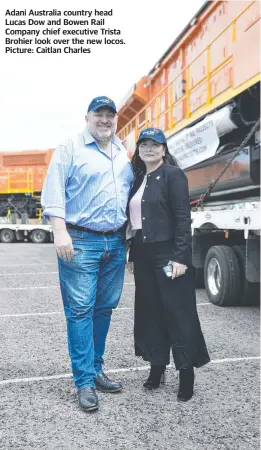  ?? ?? Adani Australia country head Lucas Dow and Bowen Rail Company chief executive Trista Brohier look over the new locos. Picture: Caitlan Charles