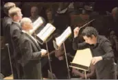  ??  ?? COUNTERTEN­ORS,
from left, Nathan Medley, Brian Cummings and Daniel Bubeck stand ready; Dudamel conducts the philharmon­ic and master chorale.