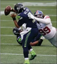  ?? (AP/Elaine Thompson) ?? Seattle Seahawks quarterbac­k Russell Wilson (3) is sacked by New York Giants defensive end Leonard Williams (99). The Giants defeated the Seahawks 17-12 to maintain their lead in the NFC East.