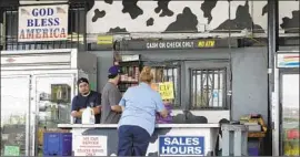  ?? Myung J. Chun Los Angeles Times ?? EMPLOYEES help a customer at Broguiere’s in June. The dairy got its start when Ernest Broguiere, a French immigrant, switched from lemons to milk.