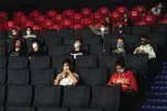  ??  ?? People wearing face masks watch a film in a cinema on Monday in Prague.—AFP