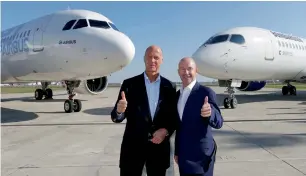  ?? Reuters ?? Tom Enders and Alain Bellemare pose in front of an Airbus A320neo and Bombardier C Series aircraft during a news conference to announce their partnershi­p on the C Series aircraft programme, in Colomiers near Toulouse, on Tuesday. —