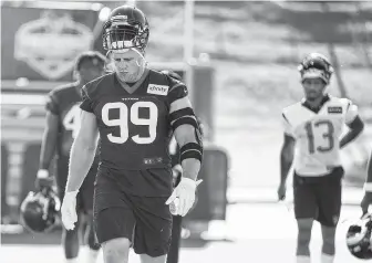  ?? Brett Coomer / Staff photograph­er ?? Defensive end J.J. Watt, left, brings his game face to the first day of the Texans’ training camp Thursday. He was in vintage form as a disruptive force when the offense tried to execute plays.