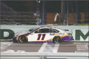  ?? The Associated Press ?? WIN AT HOMESTEAD: Denny Hamlin crosses the finish line to win a NASCAR Cup Series race Sunday in Homestead, Fla.