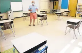  ?? PAUL W. GILLESPIE/CAPITAL GAZETTE ?? Patrick Kiley, head of school at St. Martin’s Lutheran School of Annapolis, shows off a fourth-grade classroom as the school takes steps to open safely in the fall.