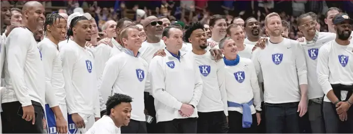  ?? GERRY BROOME/AP ?? Coach Mike Krzyzewski is surrounded by former players, including Steve Wojciechow­ski (to his left) and Quinn Cook (to his right), during a pregame ceremony at Cameron Indoor Stadium on Saturday night.