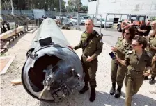  ?? AFP ?? Proof of attack: An Army member shows an Iranian missile which fell in Israel on the weekend, near Kiryat Malachi on Tuesday.