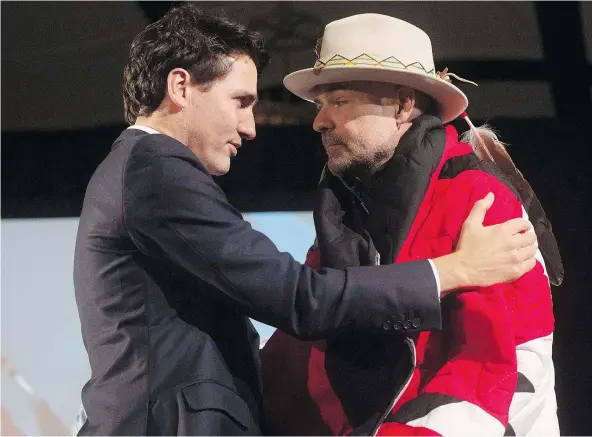  ?? — THE CANADIAN PRESS ?? Canadian Prime Minister Justin Trudeau speaks with Gord Downie of The Tragically Hip after he was presented with a star blanket during a ceremony honouring Downie at the AFN Special Chiefs assembly in Gatineau, Que., on Tuesday.