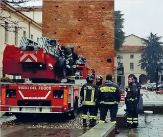  ??  ?? Monitoragg­io I vigili del fuoco ai piedi della Torre dell’orologio dopo la caduta di calcinacci (Milani)