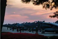  ?? (Reuters) ?? US HARRIER PILOTS from Marine Attack Squadron 311 are seen preparing for takeoff from Kunsan Air Base in South Korea late on April 26 during Exercise Max Thunder 17.