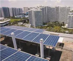  ?? REUTERSPIX ?? Solar panels on the roof of a public housing block in Singapore. The TNB-Sunseap collaborat­ion will target, among others, clients such as RE100 companies and multinatio­nal corporatio­ns.–