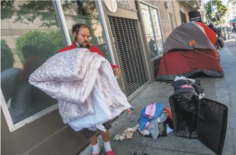  ?? Nick Otto / Special to The Chronicle ?? Above: Eric Delahonssa­ye organizes his belongings near a small tent encampment in San Francisco in July. Below: James Dixon, HealthRigh­t 360 director of residentia­l services, leads a staff meeting at the residentia­l drug treatment program in May.