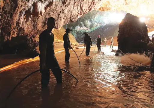  ?? HANDOUT/AFP/GETTY IMAGES ?? Thai Navy soldiers in the flooded Tham Luang cave during rescue operations for the 12 boys and their coach trapped in the cave at Khun Nam Nang Non Forest Park.