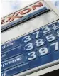  ?? PHOTO: AP ?? Petrol prices at a Pittsburgh Exxon mini-mart. Exxon Mobil investors want a climate impact analysis.