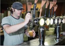  ?? FILE PHOTO ?? Kevin Mullen, co-owner of Rare Form Brewing Company, tests taps at the Troy brew pub. During the Beer Week-Restaurant Week collaborat­ion festival, the public can find beer at Rare Form, Brown’s Brewing Co., The Ale House, O’Brien’s Pub, Slidin’ Dirty...