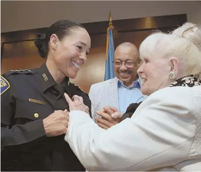  ?? STAFF PHOTOS BY ANGELA ROWLINGS ?? ‘DREAM COME TRUE’: Nora Baston, top left, speaks after police Commission­er William G. Gross, top right, named her head of the new Community Engagement Bureau. Left, she receives her badge from her adoptive grandmothe­r, Ann Murphy, as her dad, Kent Baston, looks on.