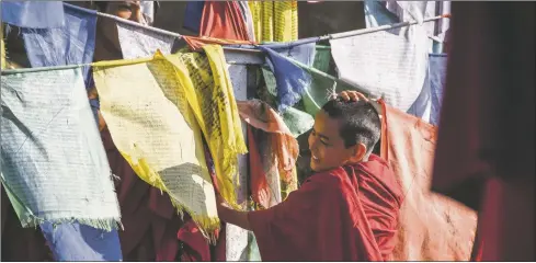  ?? COURTESY IMAGE ?? Boy and prayer flags, a still frame from Andrea Heckman’s film ‘Bon and the West.’