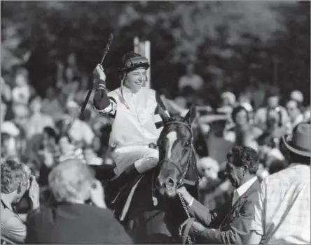  ?? ASSOCIATED PRESS FILE PHOTO ?? In this June 10, 1978, photo, jockey Steve Cauthen raises his arm in a victory salute aftfter riding Affiffirme­d to win the Belmont Stakes and Triple Crown at Belmont Park in Elmont, N.Y.